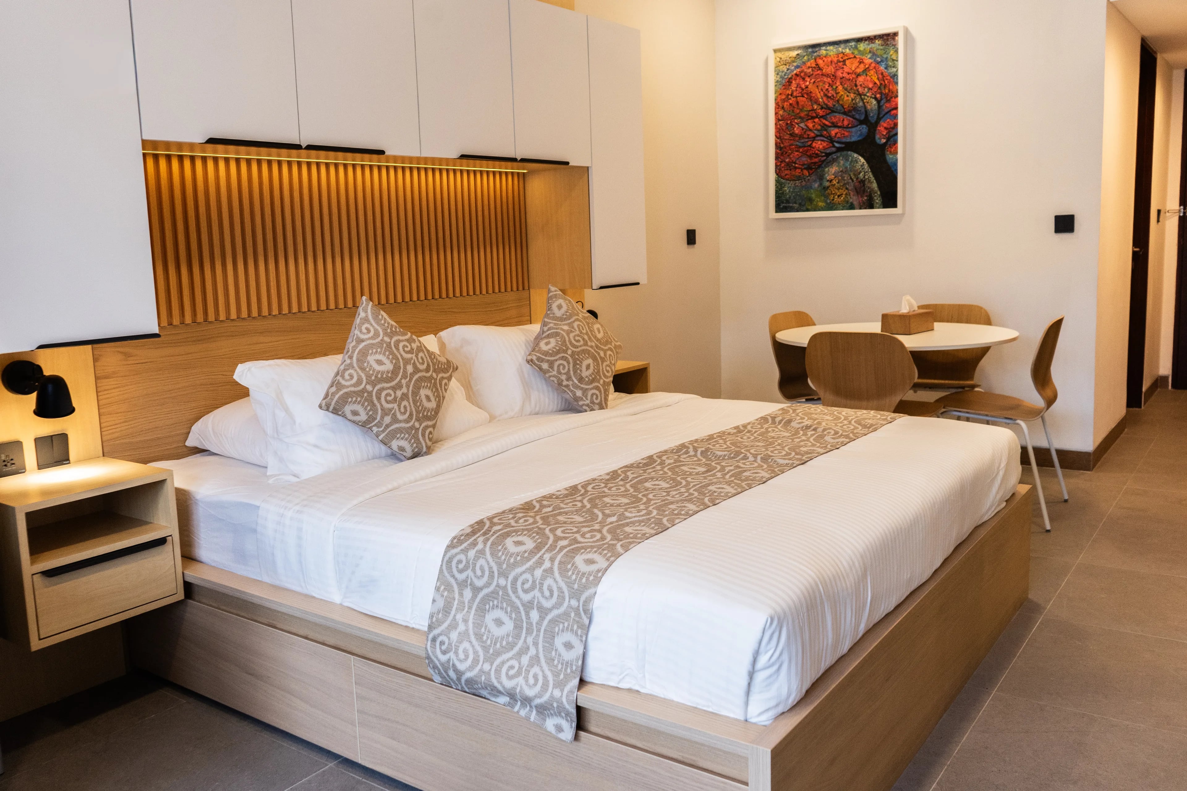 Bedroom in a renovated de Lagoon residence with built-in joinery and a dining setting