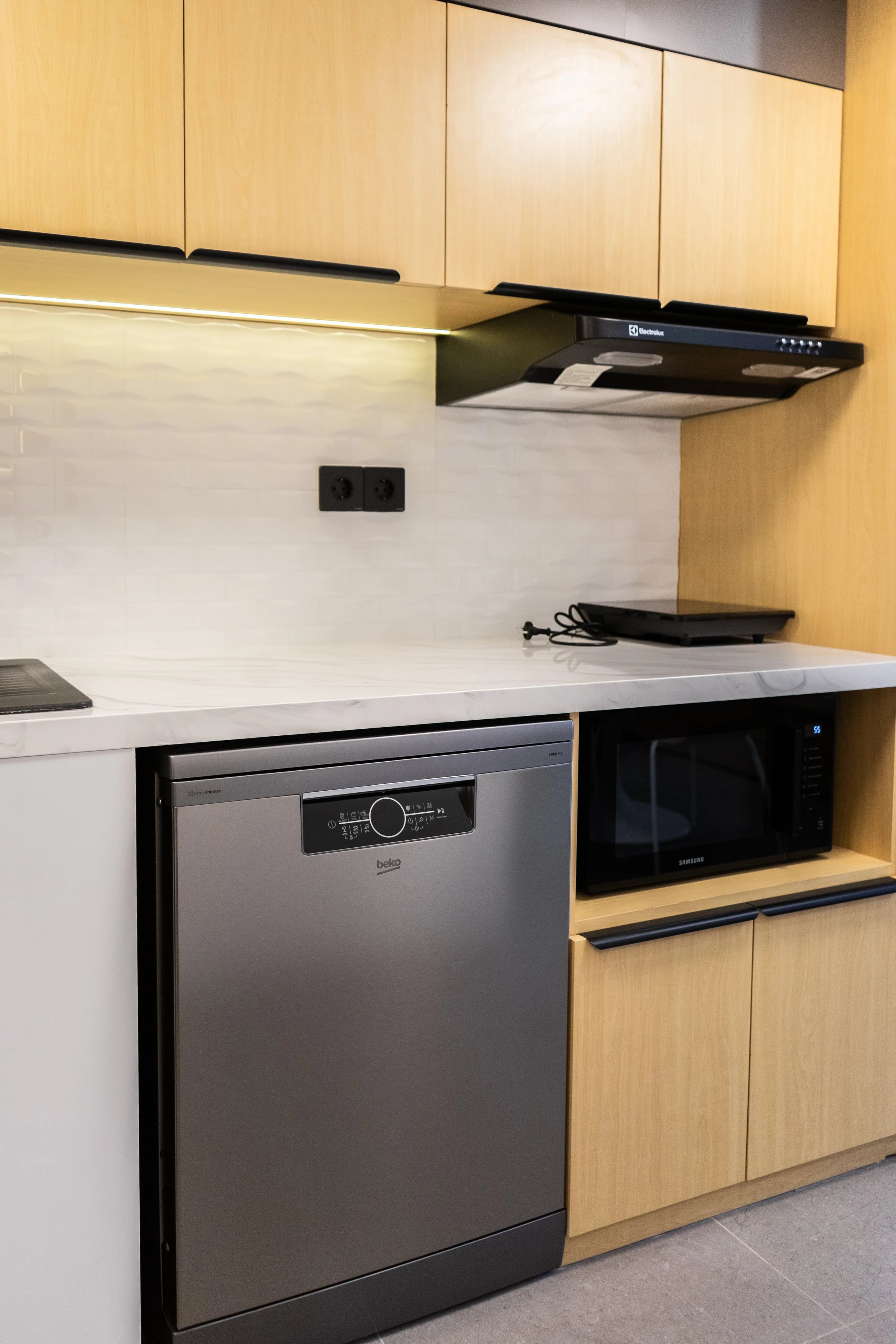 Kitchen appliances in a renovated de Lagoon residence — integrated dishwasher, microwave and rangehood