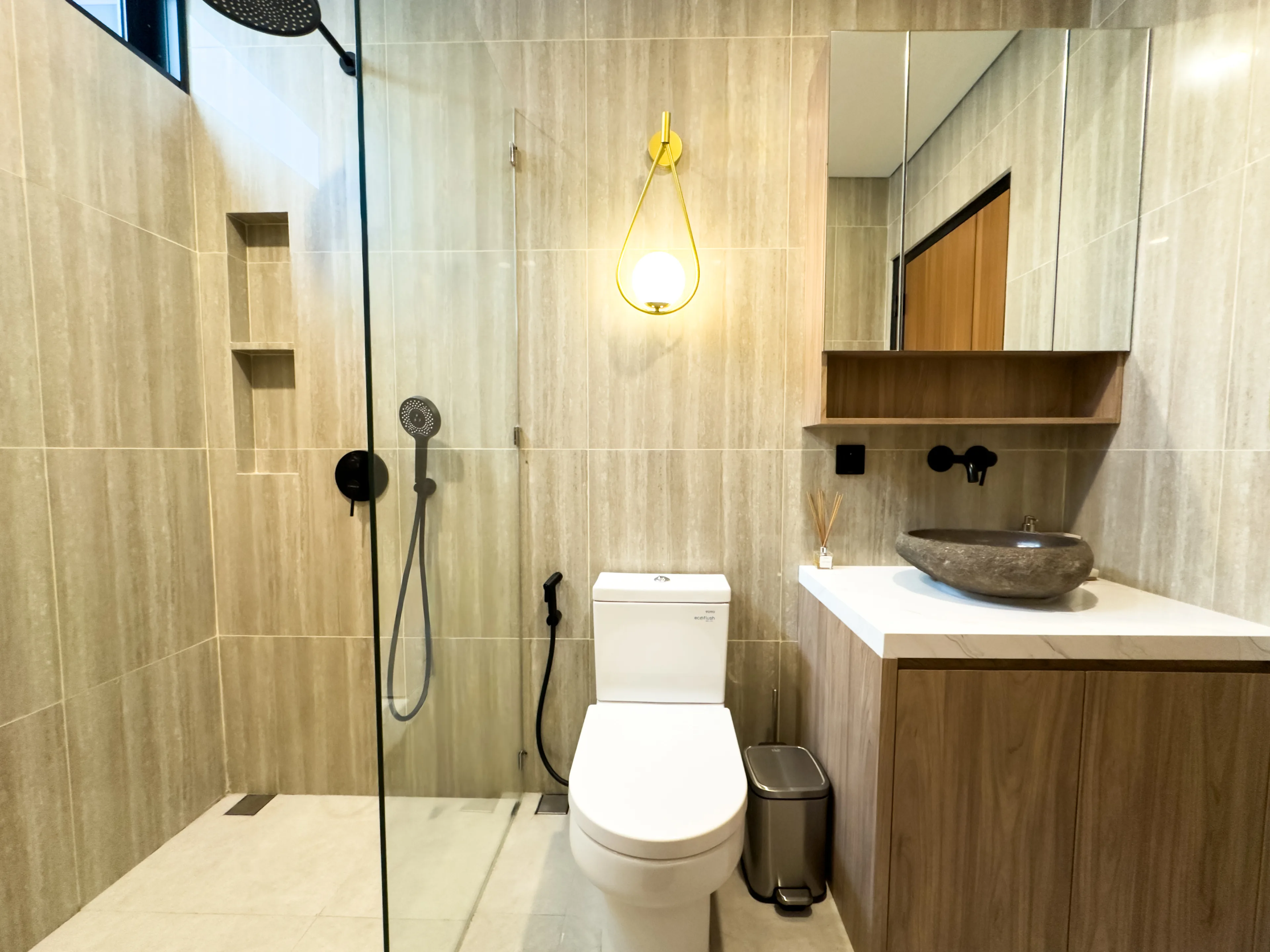 Bathroom in a delivered villa, with a walk-in shower, stone basin and timber vanity