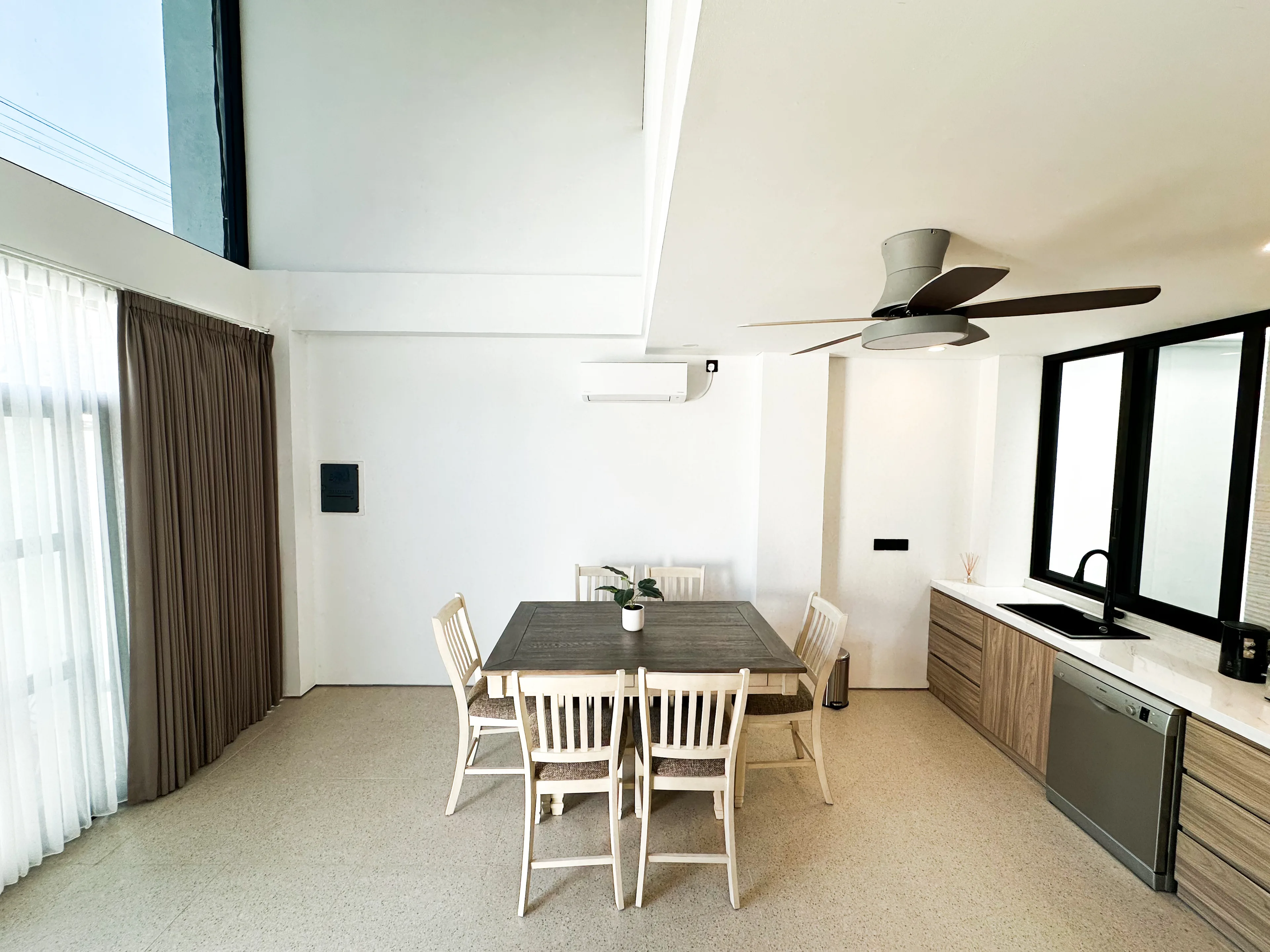 Dining table beside the kitchen bench in a delivered villa
