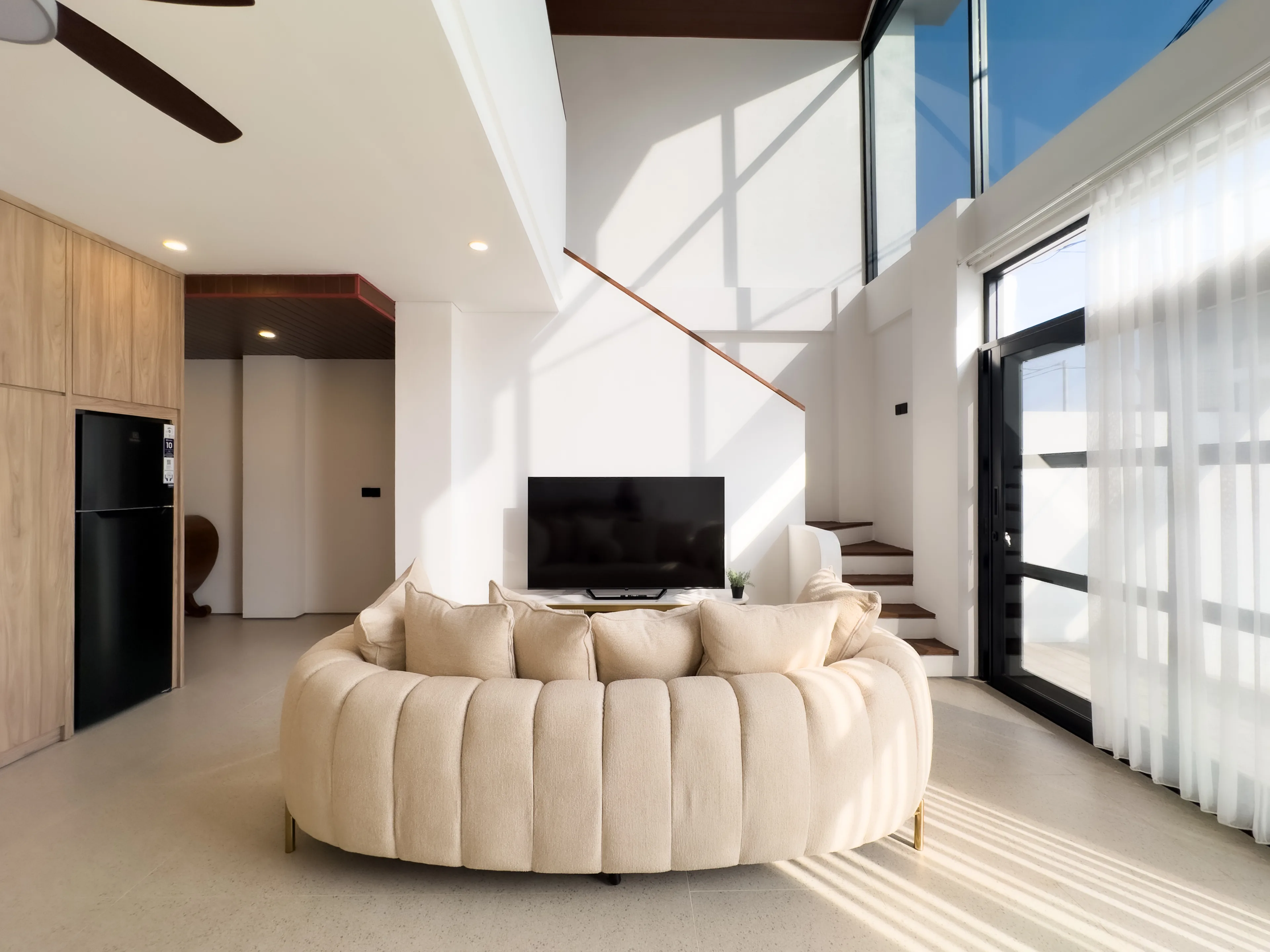 Living area of a delivered villa looking back to the stair and the kitchen